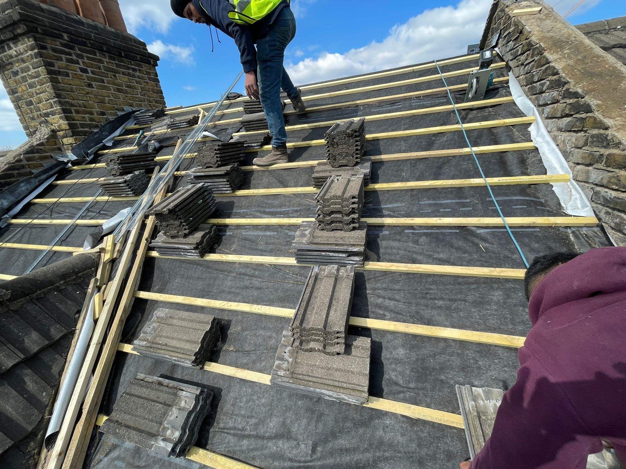 Slate roof stripped back to the battens for re-slating by GMG Roof Experts in Hillingdon