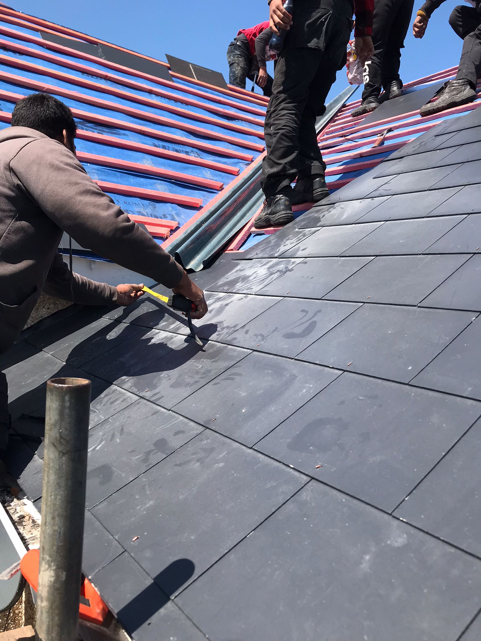 New natural slate roof being laid by GMG Roof Experts in the Hillingdon area