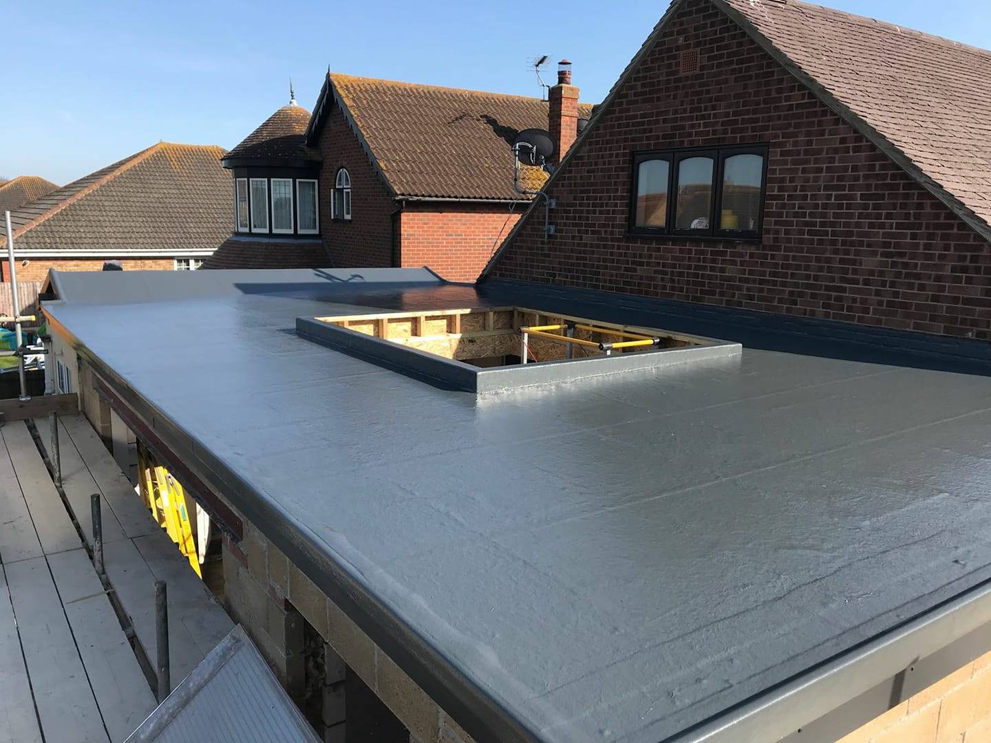 A large GRP flat roof mid-build with an opening for a roof lantern, by GMG Roof Experts in Hillingdon