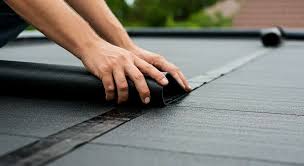 A large EPDM rubber flat roof with rainwater outlets and vents, installed by GMG Roof Experts in Hillingdon