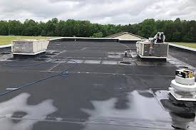 A grey EPDM rubber roof over a garage next to a house, by GMG Roof Experts in the Hillingdon area