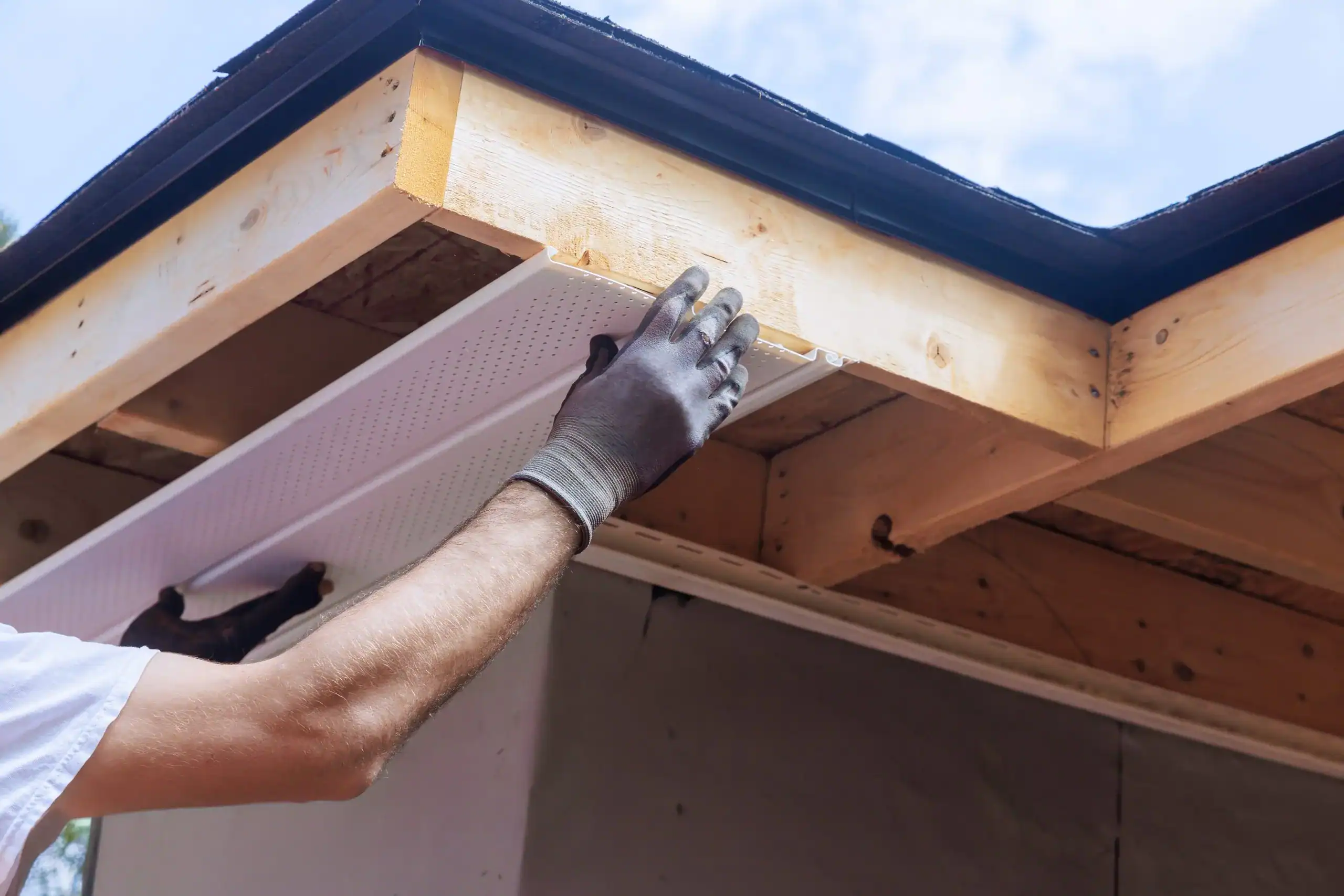 GMG Roof Experts fitting a vented uPVC soffit board under the eaves, soffit repair and replacement across the London Borough of Hillingdon