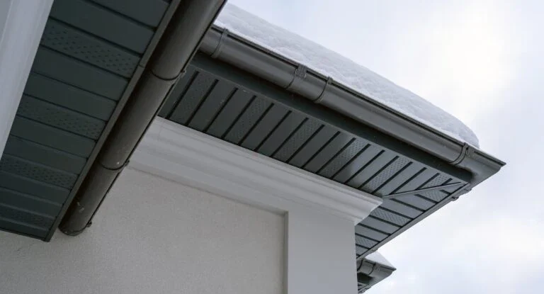 Anthracite fascia, soffit and half-round gutter on a house corner by GMG Roof Experts in Hillingdon