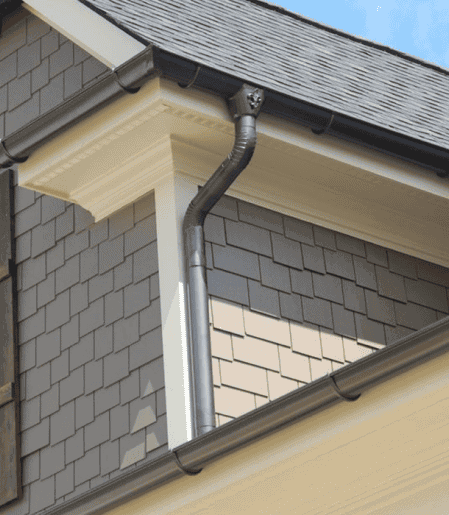 Downpipe and hopper head on a gable eaves, fitted by GMG Roof Experts in the Hillingdon area