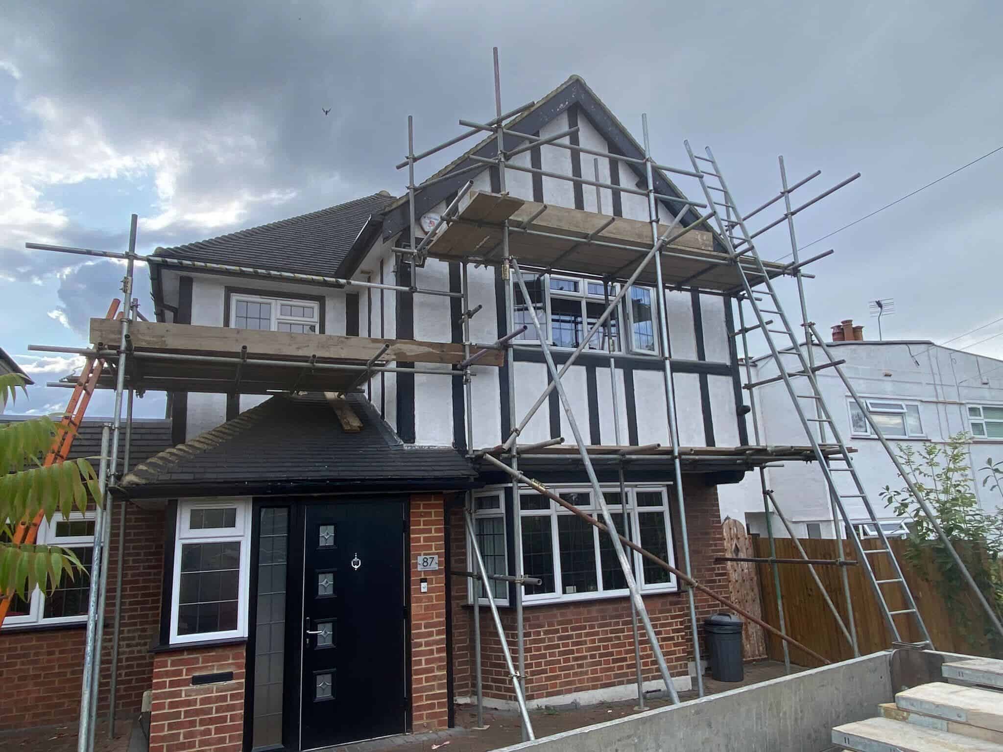 A rendered mock-Tudor semi under scaffold, brickwork and render repairs by GMG Roof Experts in the Hillingdon area