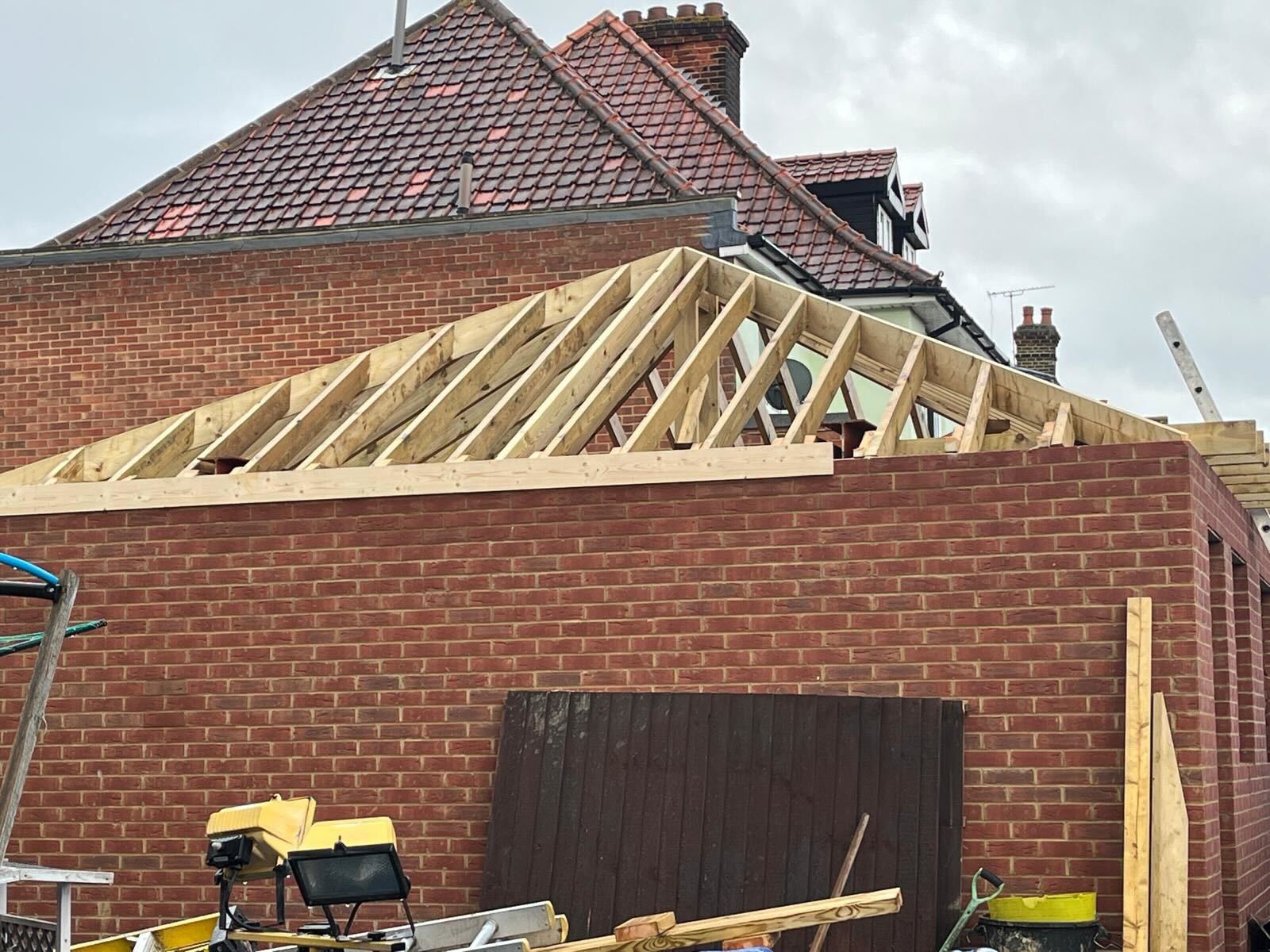 A roof timber structure being rebuilt over an extension by GMG Roof Experts