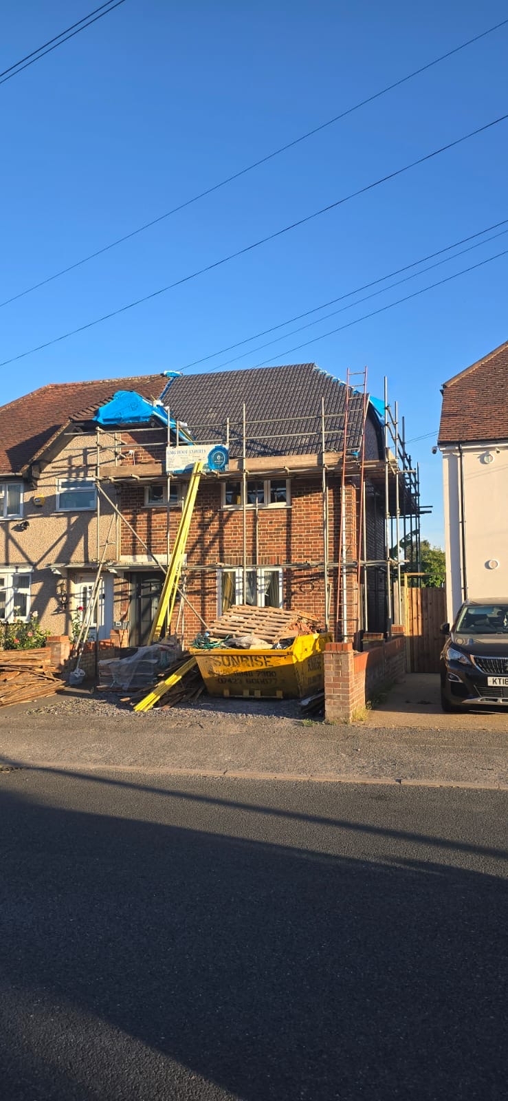 A house with the roof covered and scaffolded during an emergency repair by GMG Roof Experts in Hillingdon