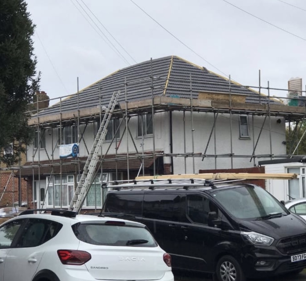 GMG Roof Experts working from a scaffold on a hipped roof mid-repair, emergency roof repairs across the London Borough of Hillingdon