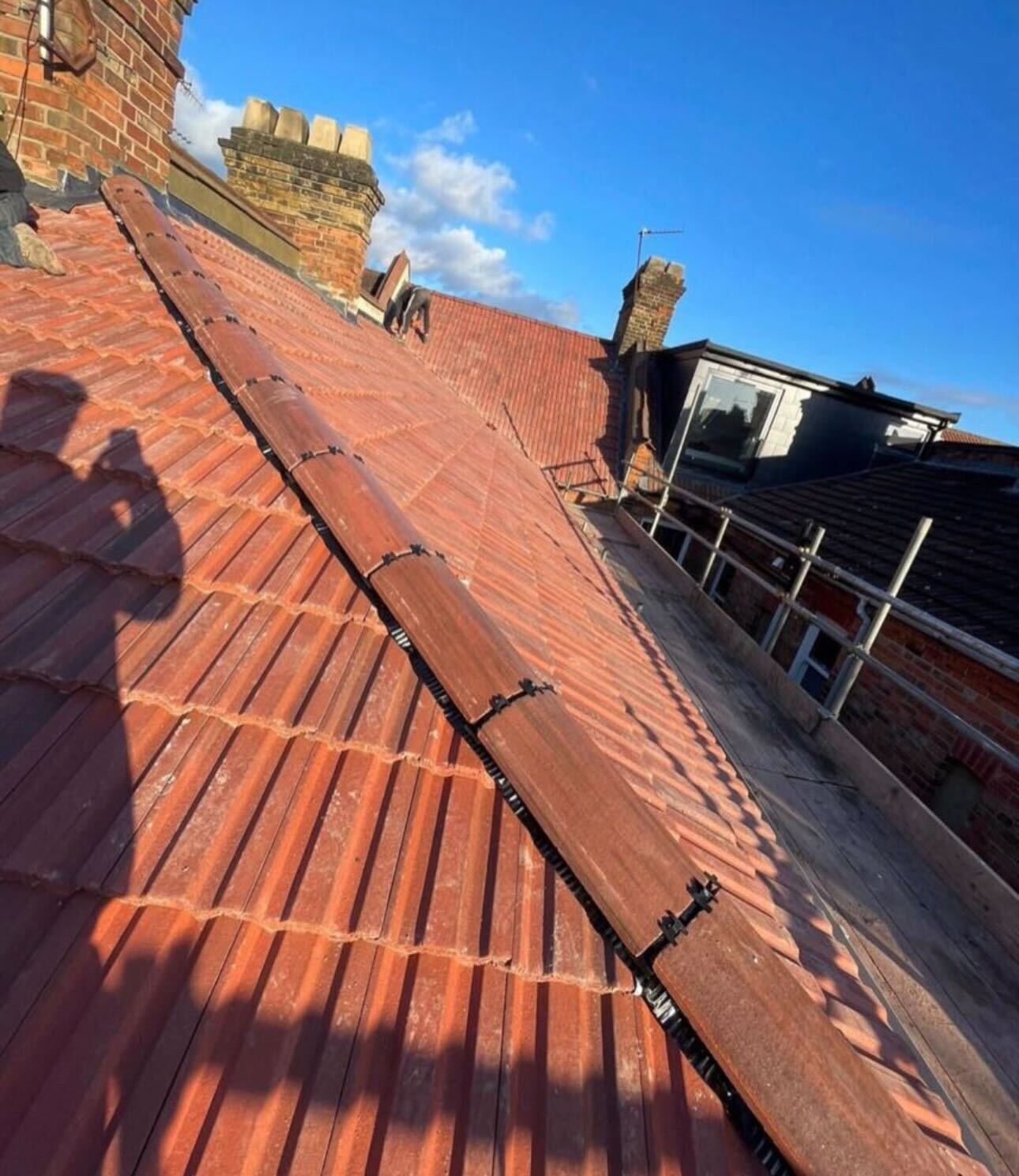 Chimney and ridge junction checked during a roof survey by GMG Roof Experts in Hillingdon