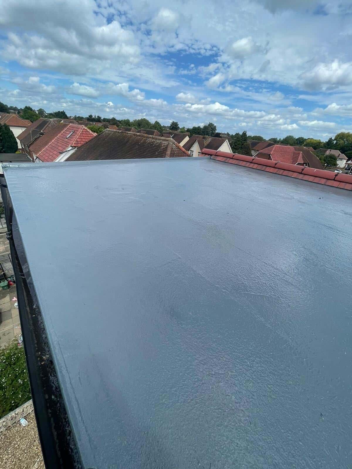 A grey GRP fibreglass flat roof laminated in a seamless finish by GMG Roof Experts in the Hillingdon area